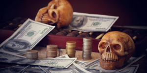 plastic skulls paying on a table amidst piles of cash and coins