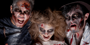three scare actors wearing zombie makeup