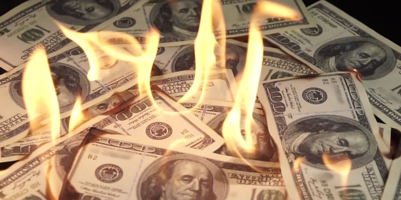 hundred dollar bills on fire