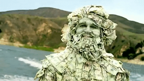 Man covered in money riding through a lake