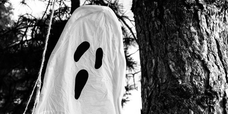 homemade ghost prop hanging from a tree