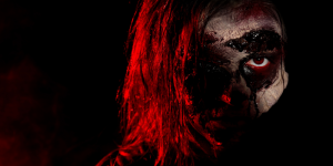 scary zombie on dark background, closeup; halloween monster