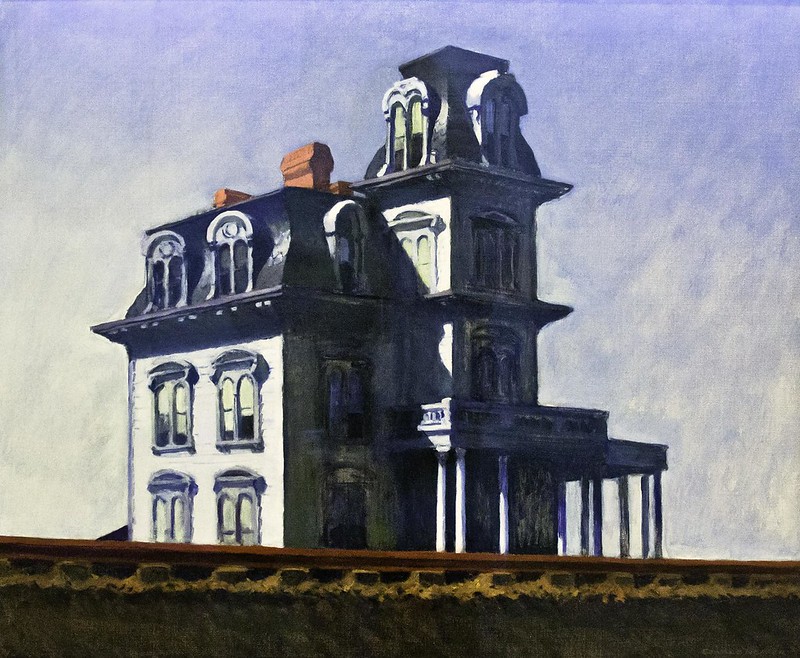 A photograph of the painting "House by the Railroad" by Edward Hopper. The painting shows a large, victorian style house.