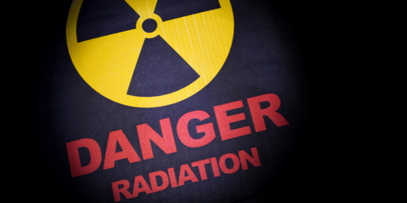 Yellow and black radiation symbol with "DANGER RADIATION" written below in large red text.