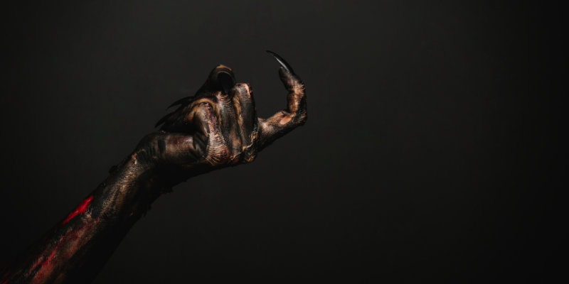 Closeup of Scary Monster Hand on Black Background